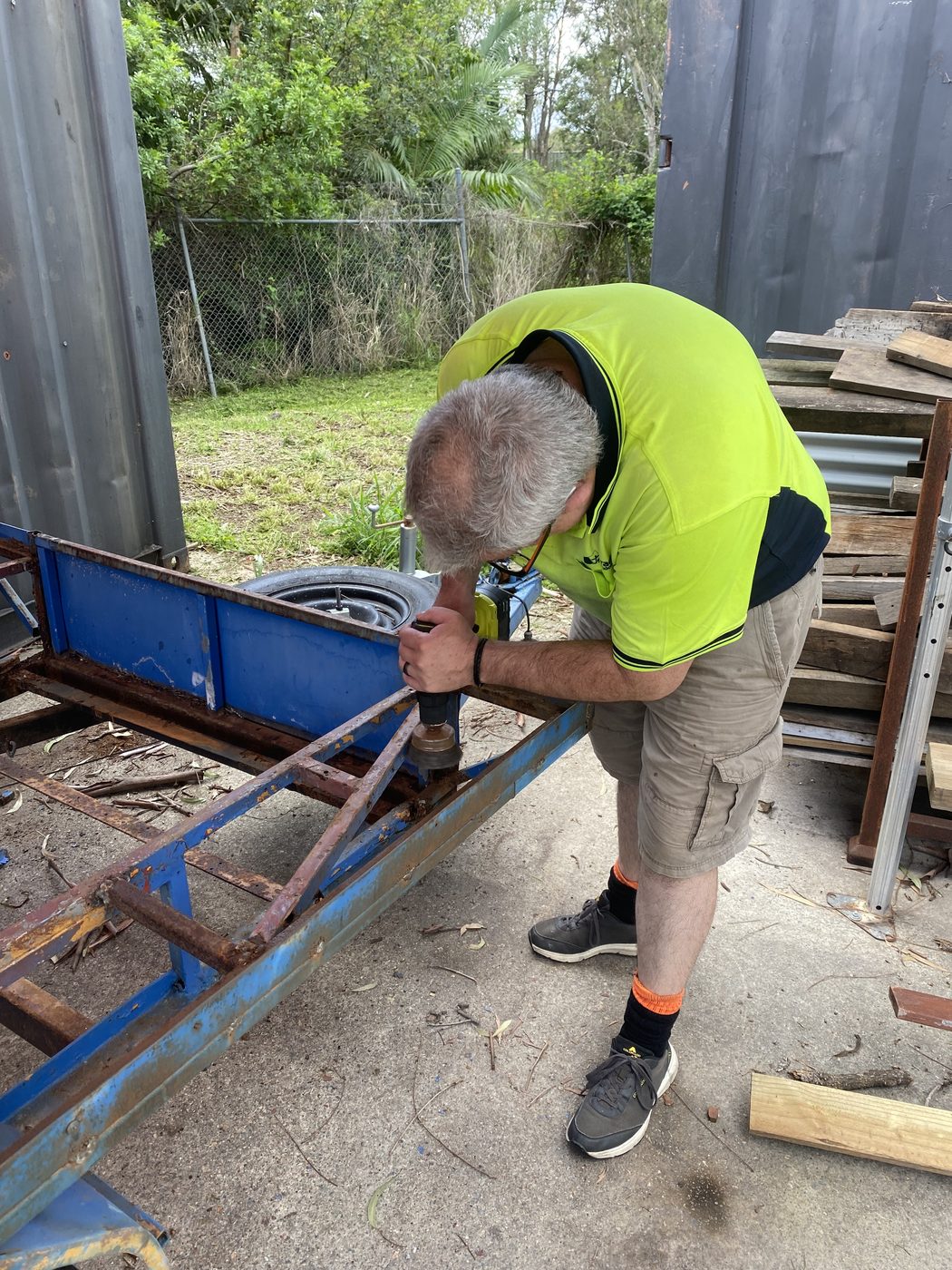 A participant using a power drill during a practical maintenance task
